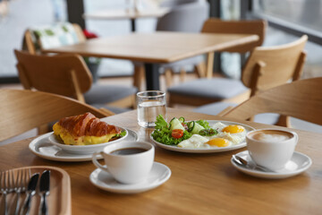 Delicious breakfast served on wooden table in cafe