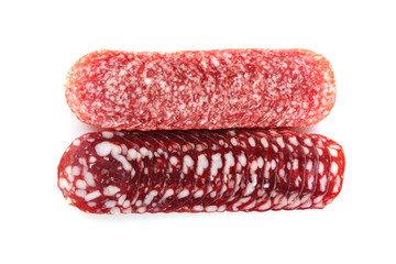 Slices of different tasty smoked sausages on white background, top view