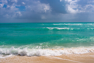 Ocean waves background. Tropical ocean waves. Blue seaside view. Foamy beach coastline. Sandy shore backdrop. Summer travel and vacation. Blue sea beach wave.
