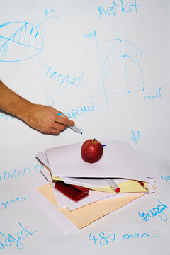 Business Planning with Handwriting, Documents, and Apple on Desk