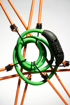 Green Cable Lock Suspended by Orange Ropes