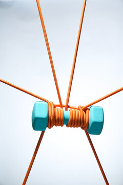 Suspended Blue Weights Wrapped in Orange Ropes