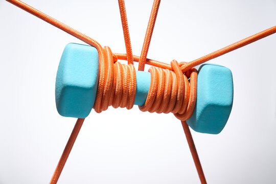 Suspended Blue Weights Wrapped in Orange Ropes