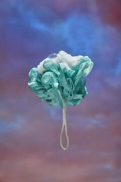 floating Loofah with Soap Bubbles Against Dreamy Background