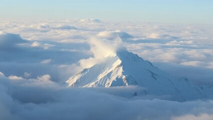 Naklejka premium Clouds veiling the snow-capped peaks in a hazy light, clouds, peak
