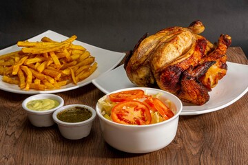 grill roasted chicken serve with french fries and salad in white plate