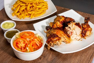 grill roasted chicken serve with french fries and salad in white plate