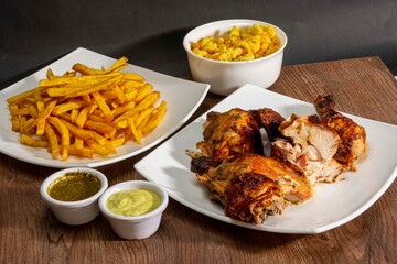 grill roasted chicken serve with french fries and salad in white plate