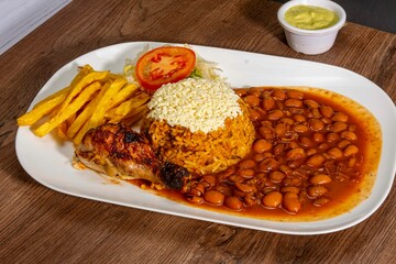grill roasted chichen serve with rice an pinto beans french fries and salad 
