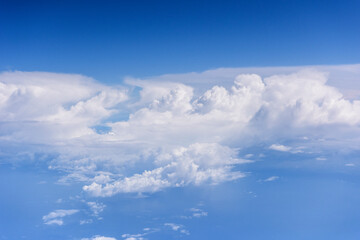 White clouds, blue sky flying into Fiji