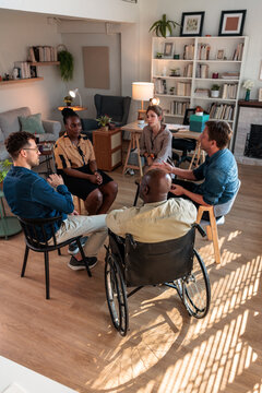 Men and women discussing thoughts during group therapy