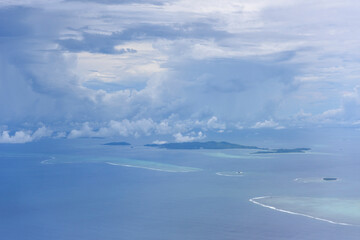 White clouds, blue sky flying into Fiji
