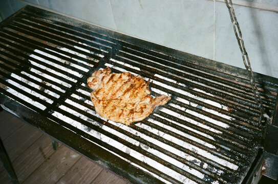 Grilled Steak Cooking On A Charcoal Grill