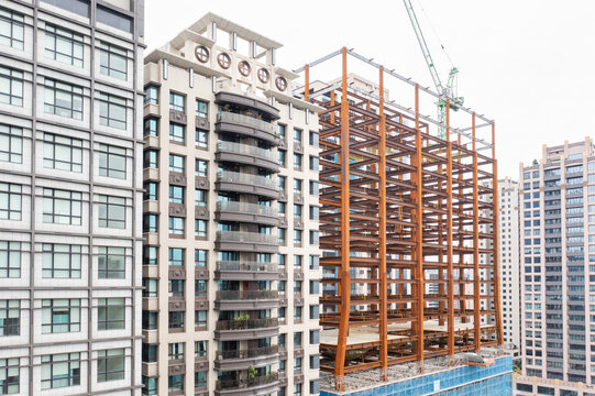 High-rise building under construction next to modern apartments