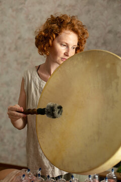 
portrait of a red-haired woman with a tambourine