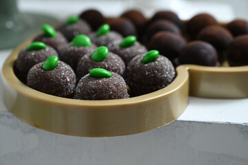chocolate truffles, brigadeiro, chocolate sprinkles, chocolate candy, condensed milk candy balls, candy balls, display with sweets, brazilian sweets, close up brigadeiro, empty space, sweet shop