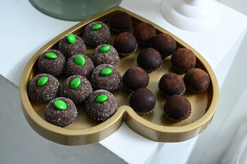 chocolate truffles, brigadeiro, chocolate sprinkles, chocolate candy, condensed milk candy balls, candy balls, display with sweets, brazilian sweets, close up brigadeiro, empty space, sweet shop