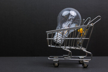 Light Bulb in a Shopping Cart Ideas and Innovation Concept. Symbolizing: innovation, ideas, creativity, business, investment.