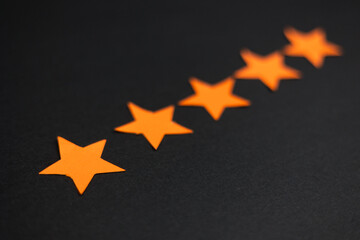 Five orange stars in a row representing a good rating and positive feedback.