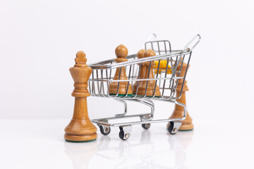 Chess Pieces in a Shopping Cart A Conceptual Image. Symbolizing marketing strategy.
