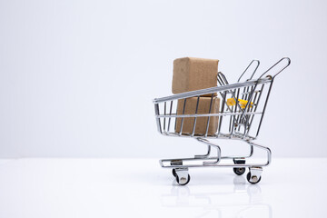 Shopping cart with two boxes. Symbolizing e-commerce, modern commerce, sale and export.