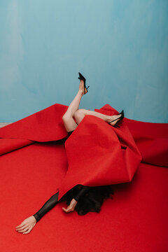Creative Concept of Red Fabric and Fashionable Black High Heels