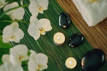 Spa setting with orchids, candles, and stones