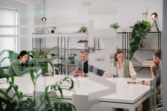 Collaborative meeting in a modern office with green decor