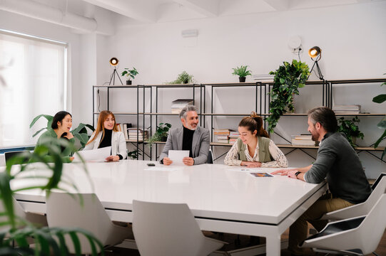 Diverse team collaborating in modern office environment