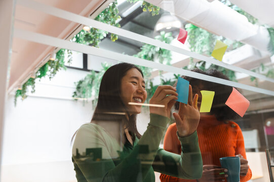 Collaborative brainstorming session with sticky notes and smiles