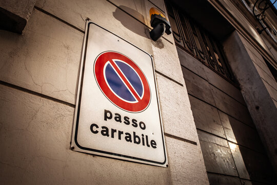 Close-up of a typical Italian 'passo carrabile' (driveway access in italian) no parking sign in Trieste, Italy, indicating restricted driveway access and highlighting local urban parking regulations.