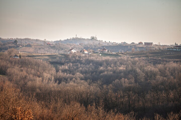 Rural houses and farms on the rolling hills of Kosmaj, Serbia, showcasing traditional farming and serene landscapes typical for the Balkan countryside. © Jerome