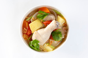 Chicken soup with potatoes, tomatoes, carrots, onions and vegetables.