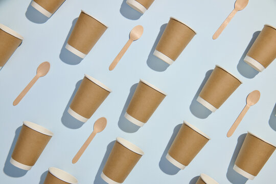 Brown Paper Cups and Wooden Spoons Pattern on Light Blue Background