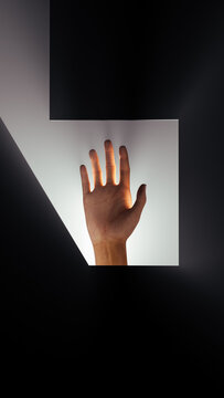 Hand reaching out for help in soft back light setting