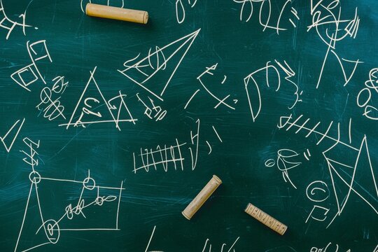 Abstract Geometric Shapes and Equations on Chalkboard Surface