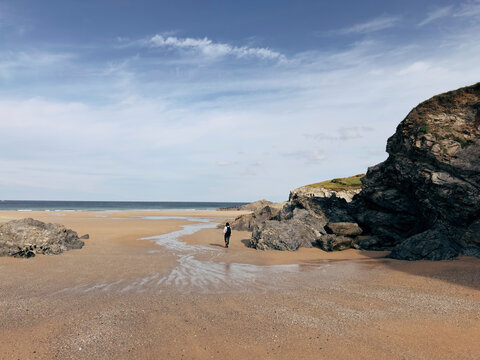 Person walking on a sandy beach