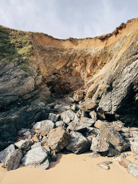 Coastal erosion of rocky cliff and sandy beach