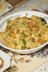 Traditional savory dish with vegetables and grains served in a bowl