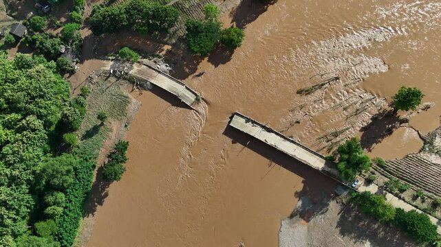 Aerial view of small bridge in Mae Yao district of Chiang Rai province collapsed after Mae Kok river flooding.