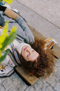 Woman in a sweater on a bench in the park