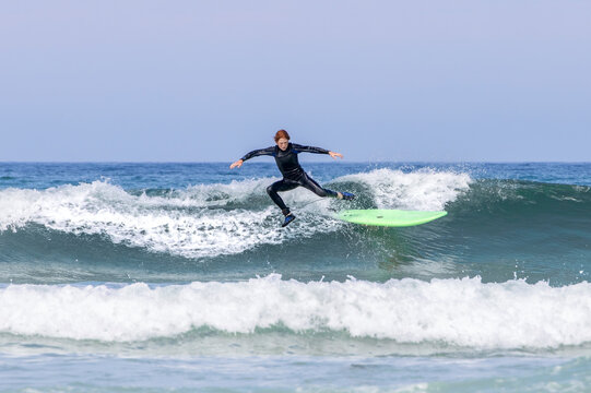 Boy falling from surfboard.