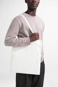 Stylish Man Holding a Blank Tote Bag Mockup