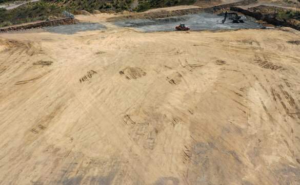 Roller and Excavator on a Large Construction Site