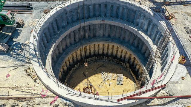Aerial View of Construction Site with Workers and Heavy Machinery