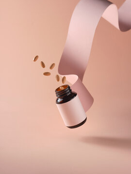 Brown medicine bottle with a label and scattering pills