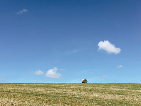 Lonely Hay Bale on Open Field