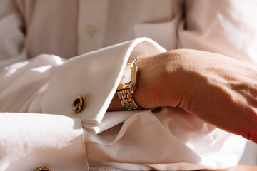 Elegant wristwatch displayed on a person's cuffed shirt
