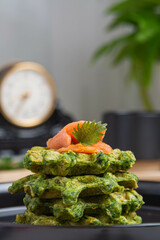 Healthy eating. Spinach and fish waffles for breakfast.