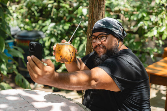 Selfie with coconut in a tropical setting